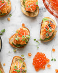 Red Caviar on canapes assored on a marble tray