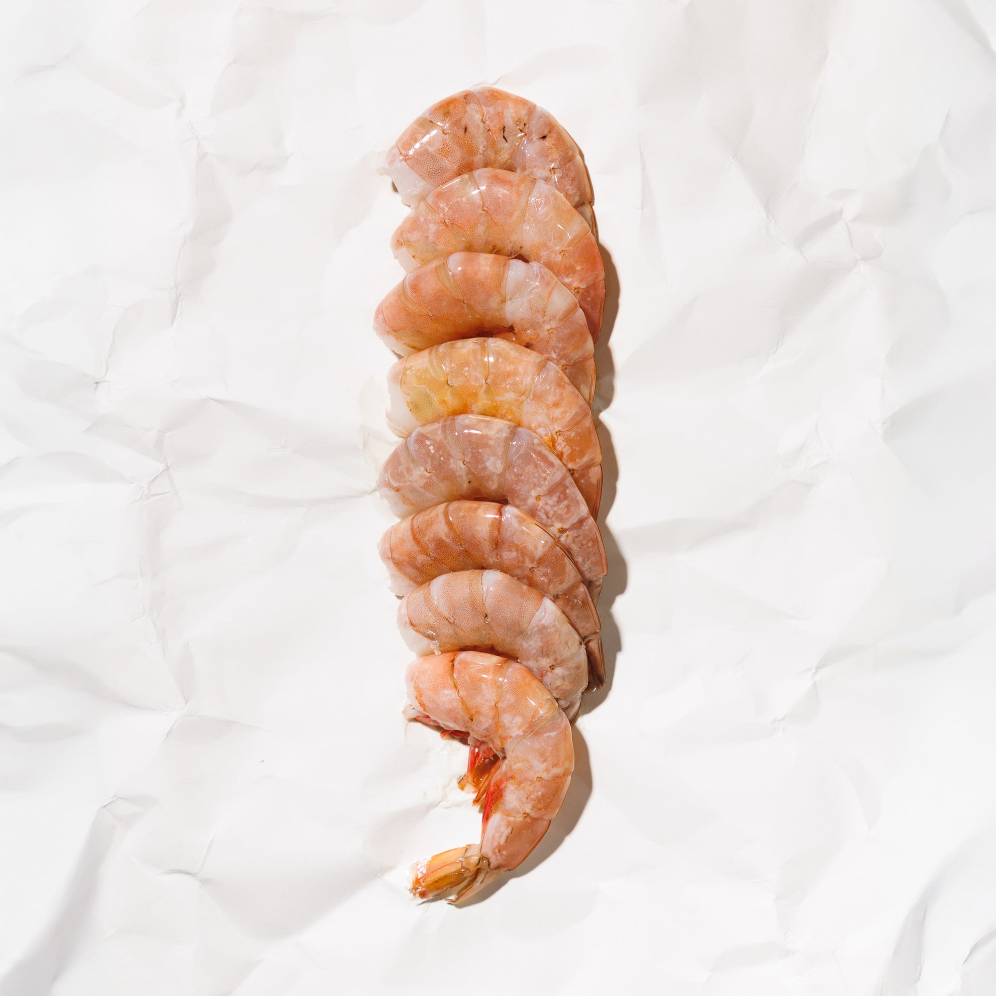 Raw shrimp with shell on a white background