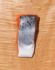 raw coho salmon portion skin side up on a wooden cutting board