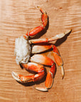 Dungeness crab cluster on a wooden cutting board