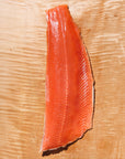Raw Keta salmon fillet on a wooden cutting board