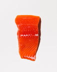 raw king salmon portion on a white background