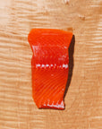Raw king salmon portion on a wooden background