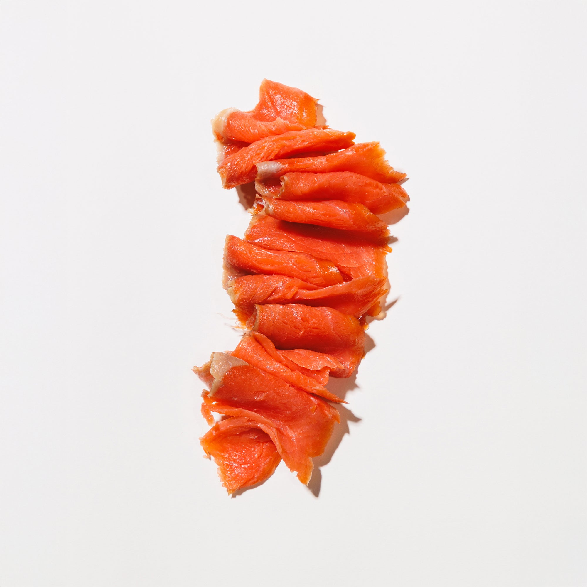 Cold smoked salmon nova on a white background