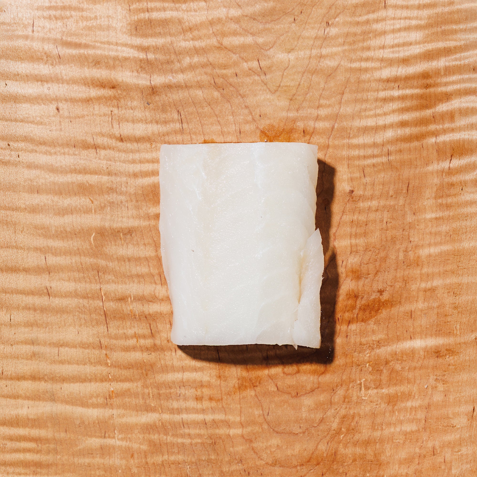 raw pacific cod on a wooden background