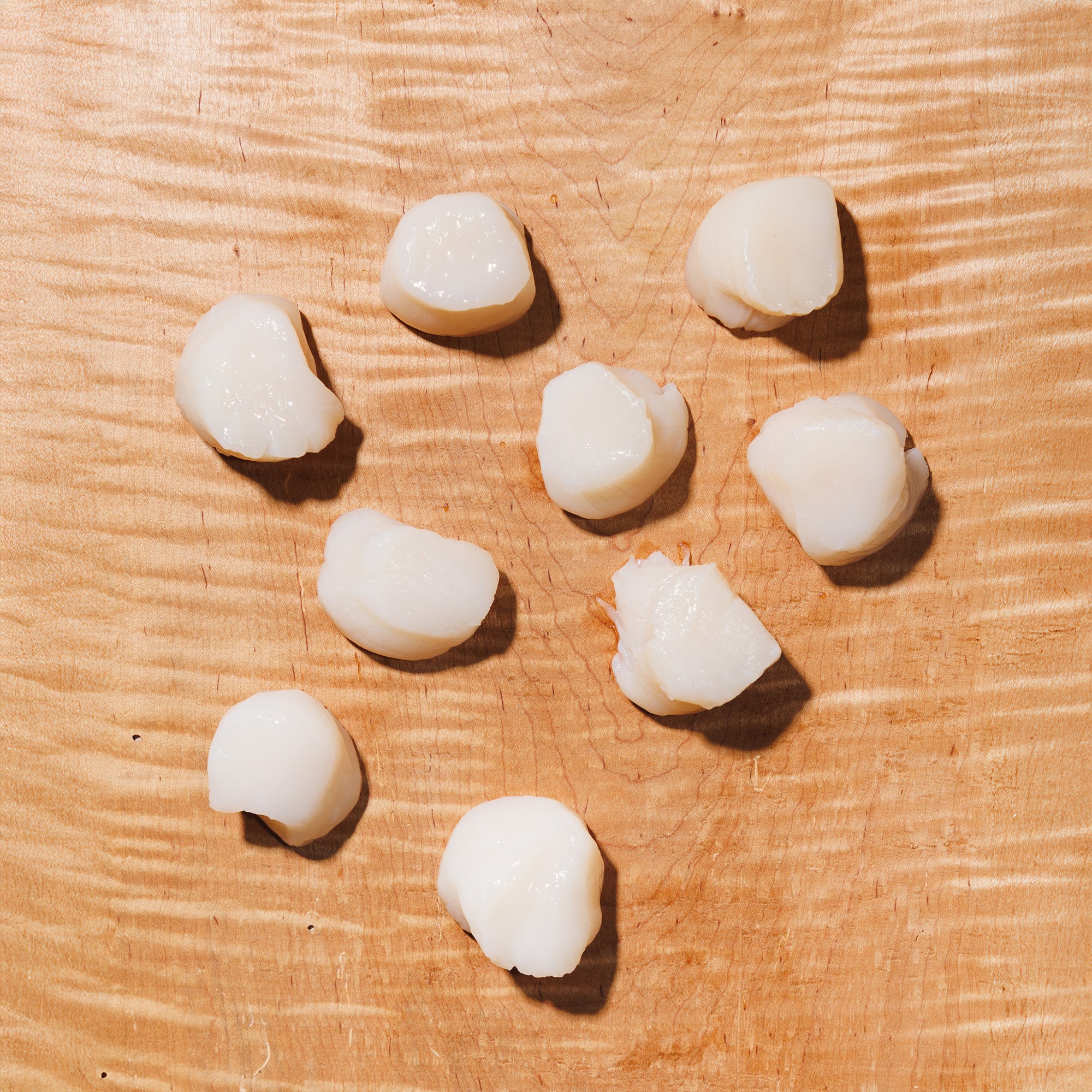 Scallops on a wooden surface