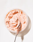 smoked salmon spread with serving knife in container on white background