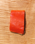 Raw sockeye salmon fillet on a wooden cutting board