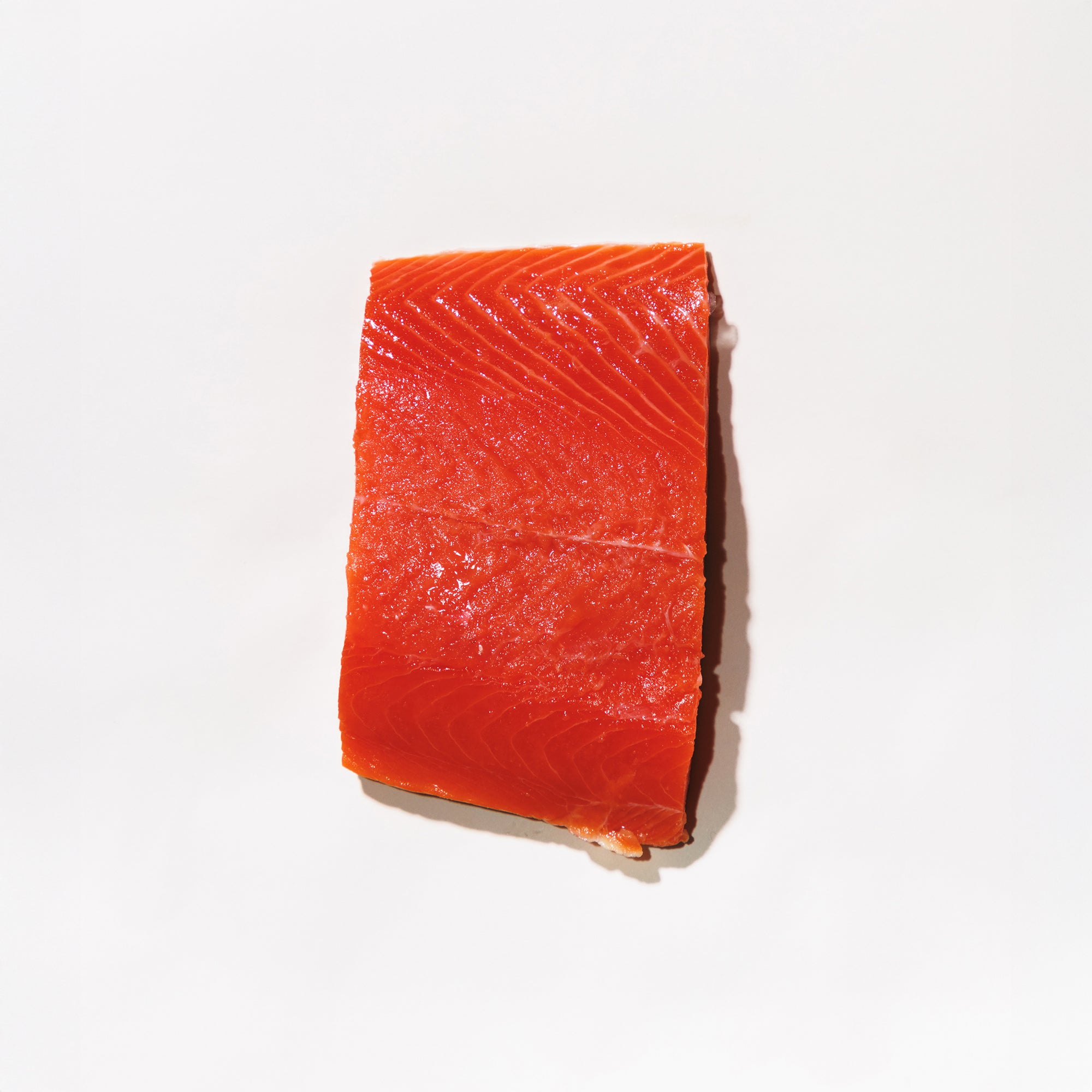 Raw sockeye salmon fillet on a white background
