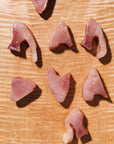 Slices of raw tuna on a wooden cutting board