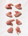 Raw tuna medallions on a white background
