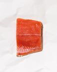 raw keta salmon on a white paper background