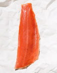 Raw keta salmon fillet on a white paper background