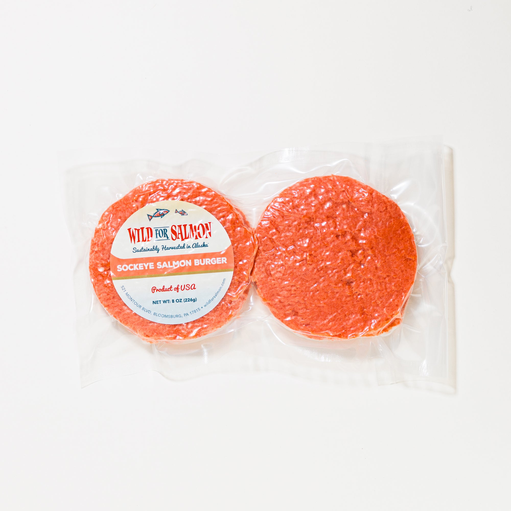 Two packages of sockeye salmon burger with a label on a white background