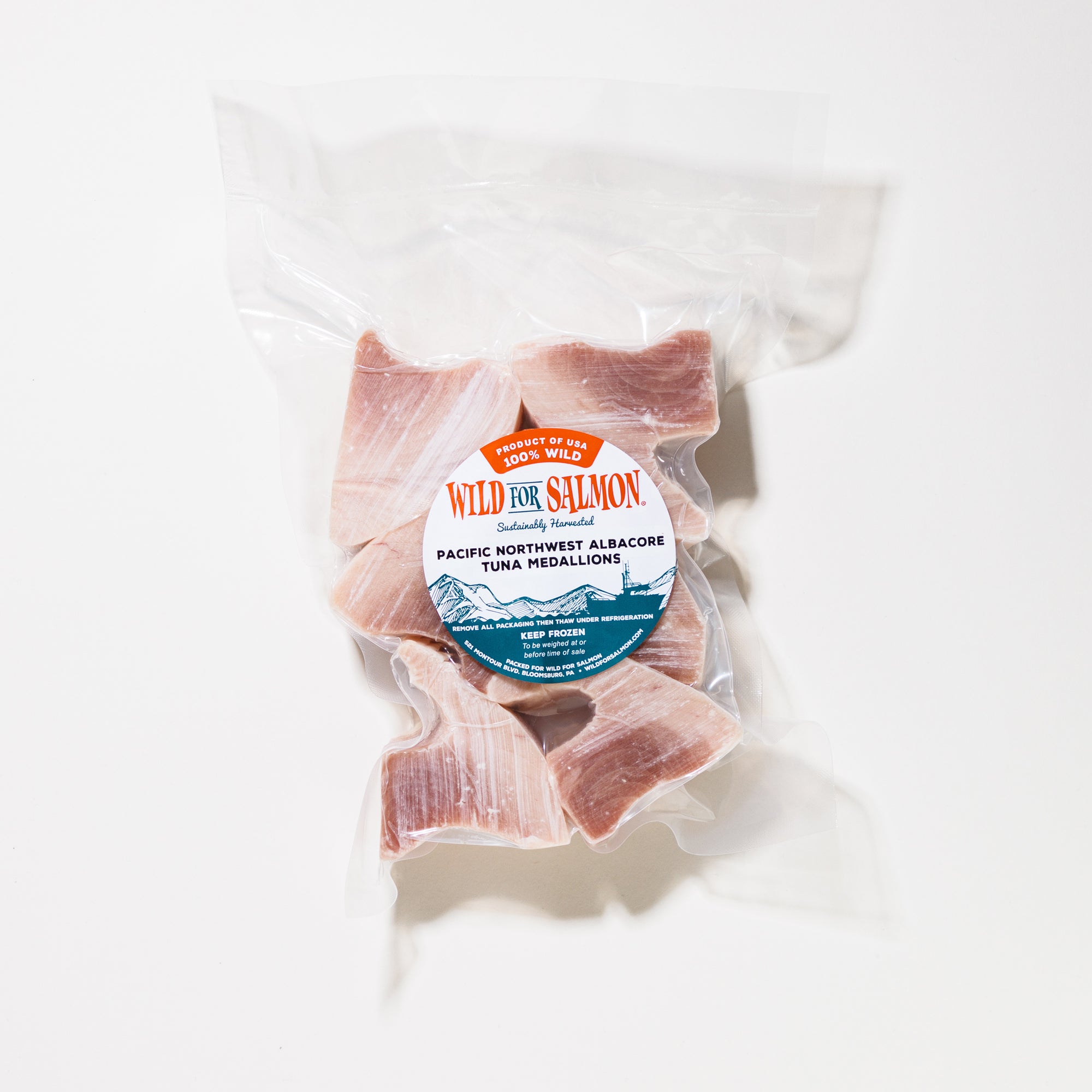 Packaged tuna medallions with a 'Wild for Salmon' label on a white background